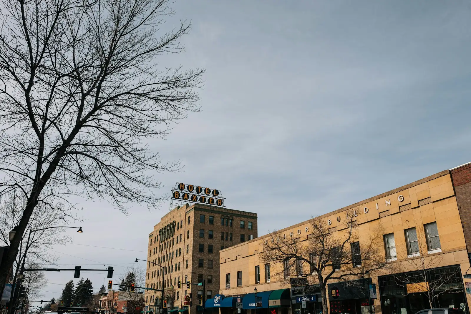 The Hotel Baxter sign above brick storefronts on Main Street in Bozeman, Montana.