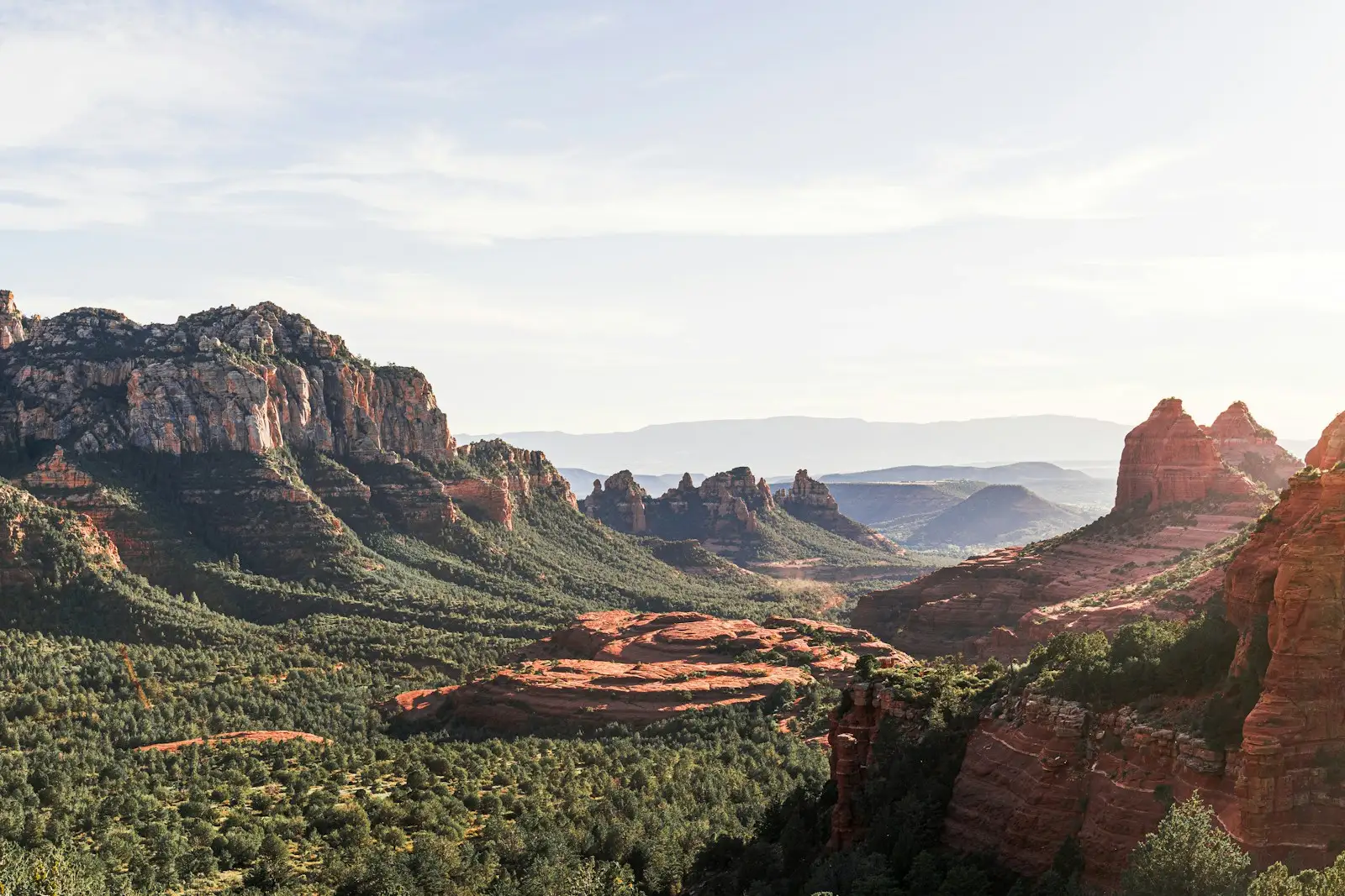 Distant red rock formations and trees seen from Schnebly Hill Road near Sedona, Arizona.